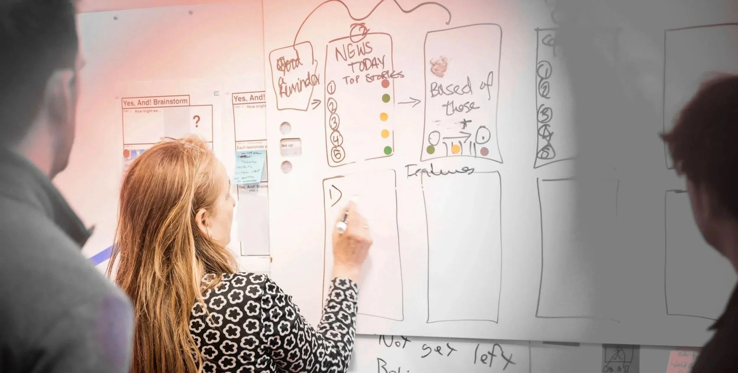 Hands collaborating around a shared canvas of ideas