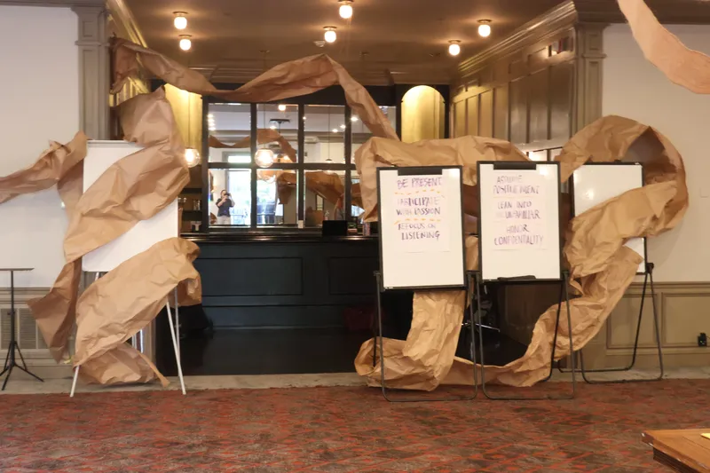 Brown-paper installation around the room entrance and flip charts