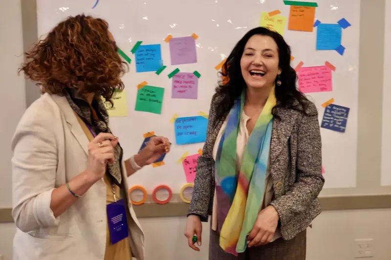 Saffron Samuels with a colleague at the intentions wall