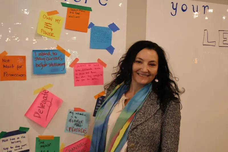 Saffron Samuels beside the participant intentions wall