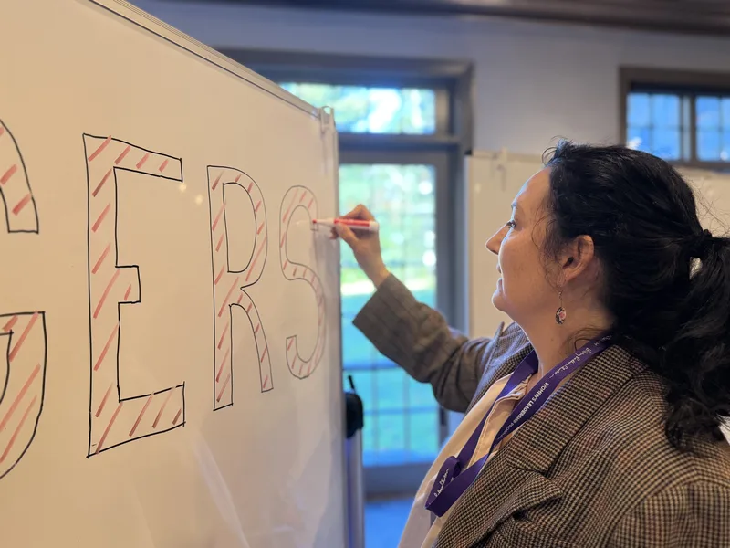 Saffron Samuels outlining letters in red