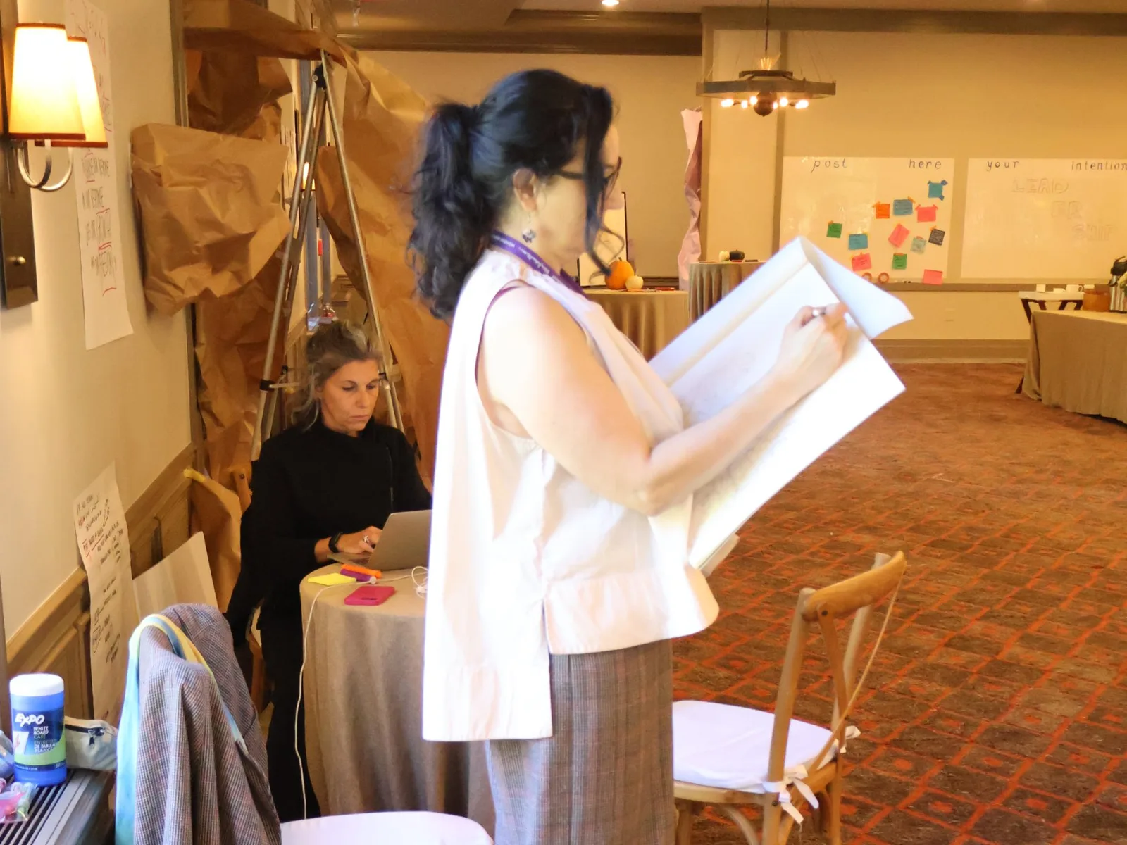 Saffron Samuels sketching in a leadership program room she designed